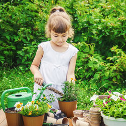 Portrait of young woman picking plants