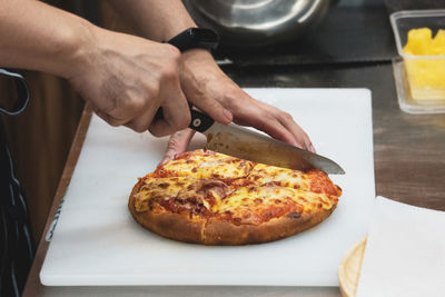 Cropped hand of man preparing food