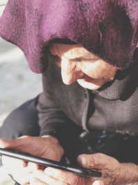 High angle view of woman holding mobile phone