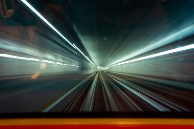 Blurred motion of train at illuminated tunnel