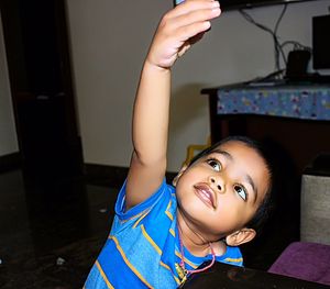 Cute boy looking up at home