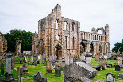 Tombstones by ruined structure