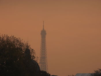 Low angle view of tower against sky during sunset