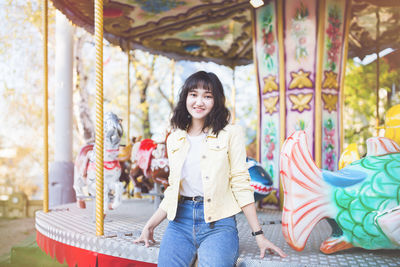 Beautiful asian girl in an amusement park, smiling