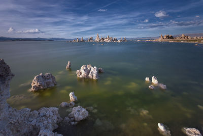 Idyllic shot of rock formations in mono lake against sky