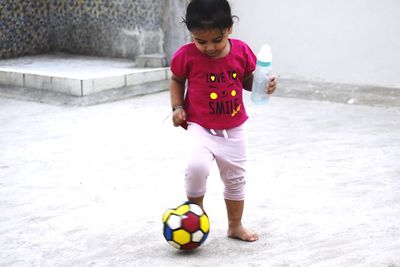 Full length of boy playing with ball