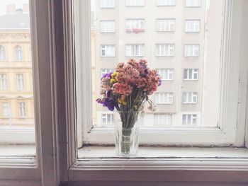 Flowers in vase on window sill
