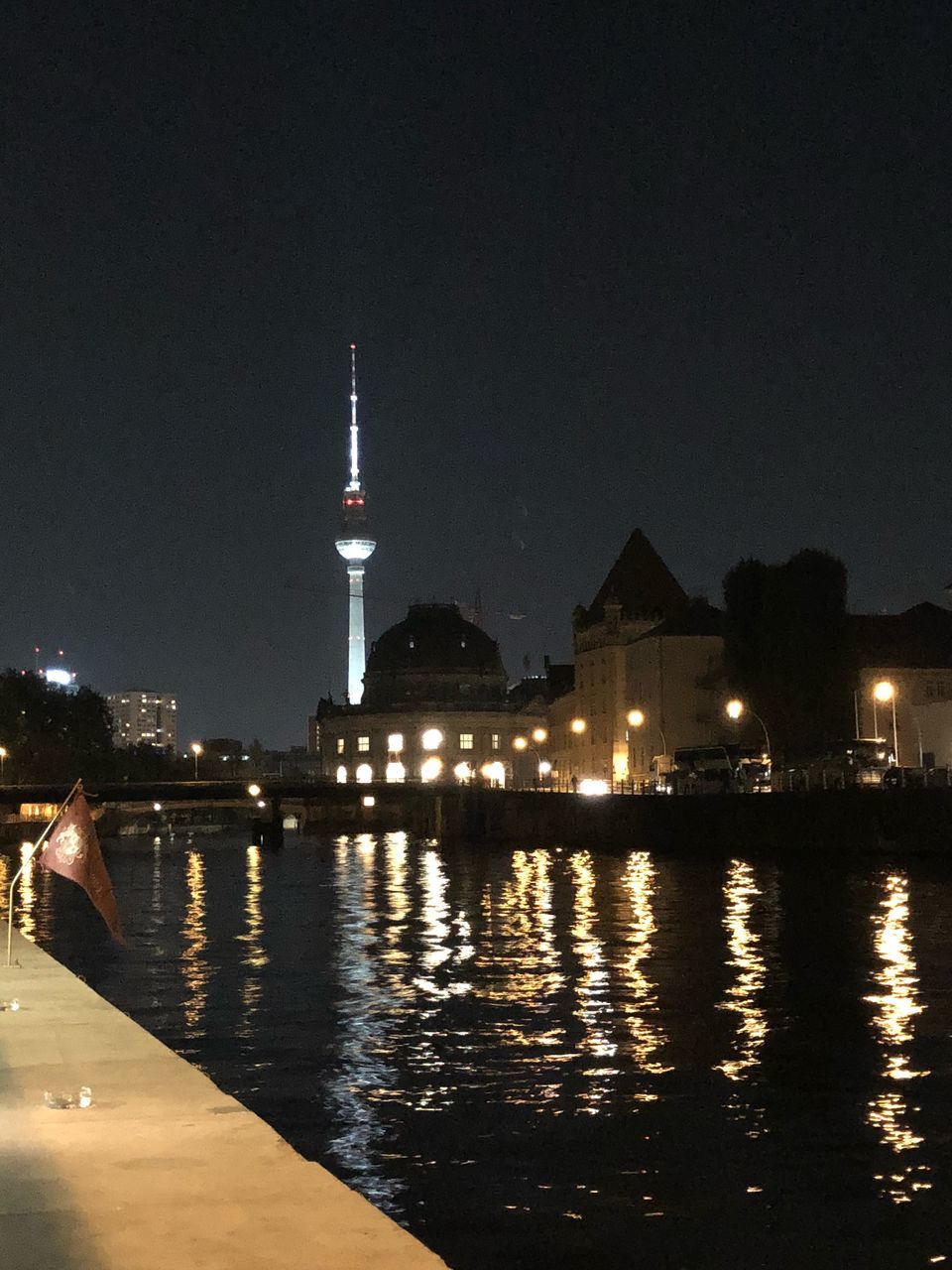 RIVER WITH ILLUMINATED BUILDINGS IN BACKGROUND