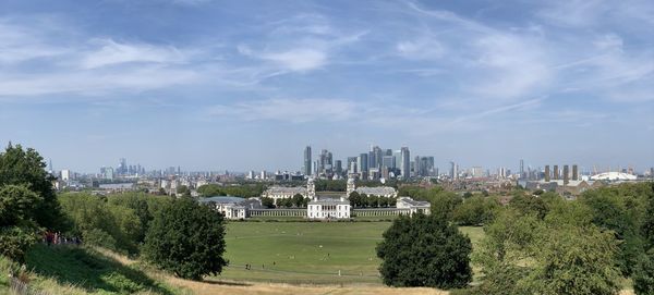 Panoramic view of buildings in city against sky