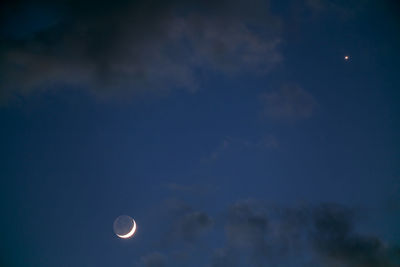 Low angle view of moon against sky at night