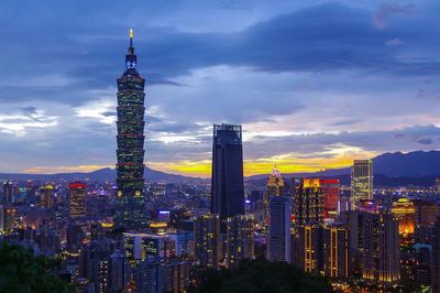 Illuminated cityscape against sky