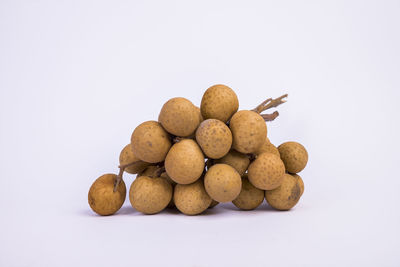 Close-up of bread in plate against white background