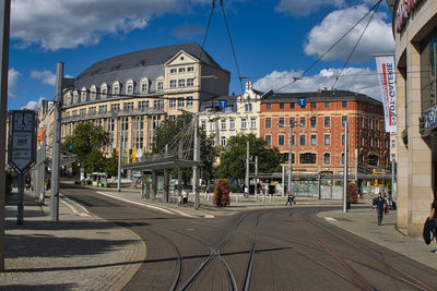 City street by buildings against sky