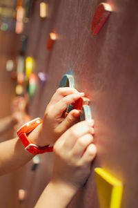 Children paly puzzles on the wall.