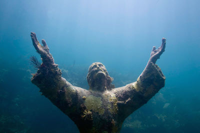 Close-up of jesus christ statue in sea