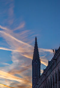 Low angle view of tower against cloudy sky