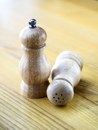 Close-up of salt and pepper wooden cellars on table