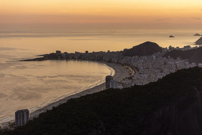 High angle view of buildings against cloudy sky during sunset