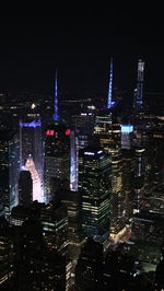Aerial view of illuminated buildings in city at night