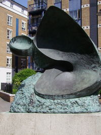 Close-up of statue against buildings in city