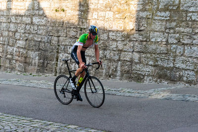 Full length of man riding bicycle