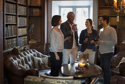 Business people with wineglasses spending leisure time at restaurant lobby