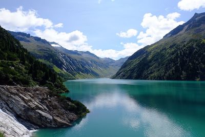 Scenic view of lake and mountains against sky