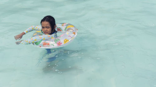 Portraits of asian girl wearing a swimsuit. swimming in the pool
