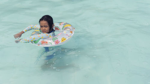 Portrait of boy swimming in pool