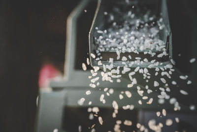 Close-up of person photographing through wet glass