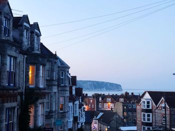 Buildings in city against clear sky