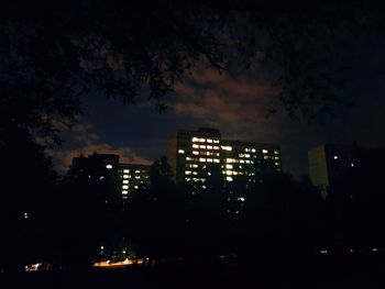 Illuminated cityscape against sky at night