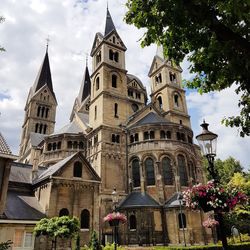 Low angle view of bell tower against cloudy sky