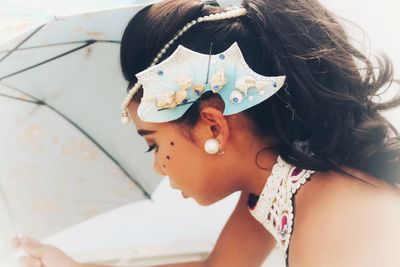 Side view of girl wearing headdress