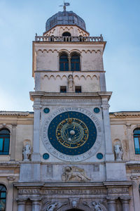 Low angle view of clock tower against sky