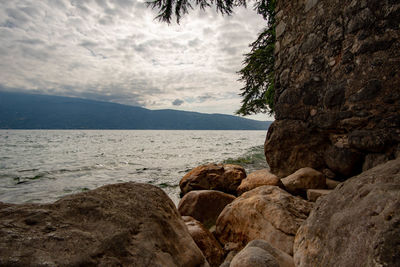 Rocks on beach against sky