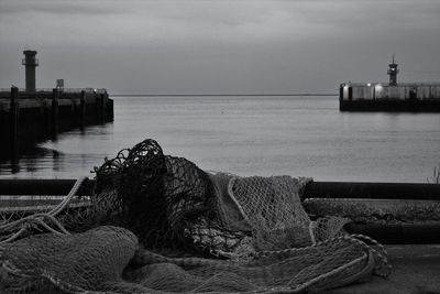 Black and white of pier against evening sky. gate to the open sea