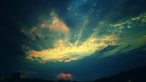 Low angle view of silhouette trees against sky at sunset