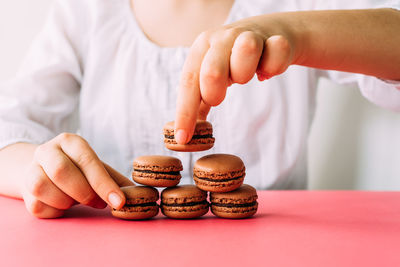 Midsection of child holding cookies