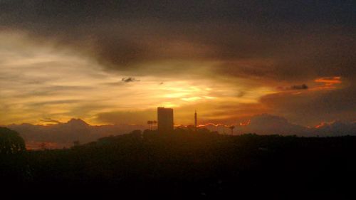 Scenic view of cityscape against sky at sunset