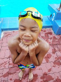 Full length of shirtless boy swimming in pool