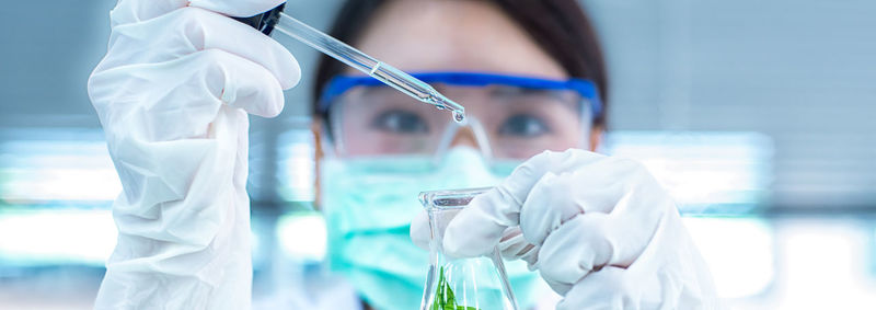 Close-up of female scientist experimenting in laboratory