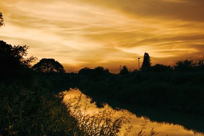 Scenic view of lake against orange sky