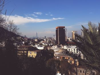 View of cityscape against blue sky