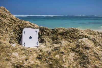 View of rock on beach against sky