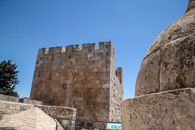 Low angle view of old building against blue sky