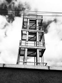 Low angle view of tower against cloudy sky