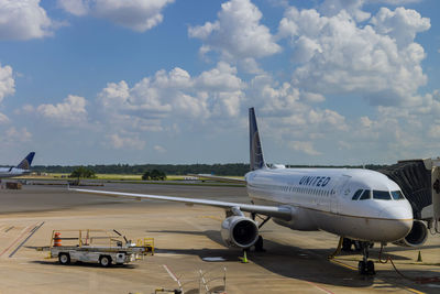 Airplane on runway against sky