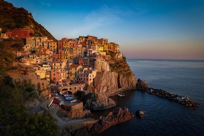 High angle view of houses by sea against sky