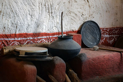 Close-up of old objects on table against wall